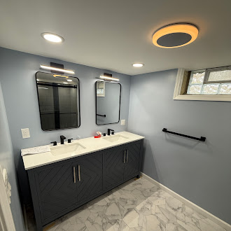 Bathroom renovation with double vanity, modern mirrors, and luxury vinyl tile floor