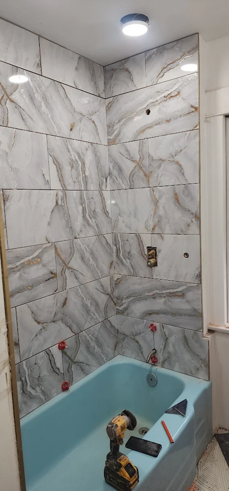 Large-format marble-look porcelain tile tub and shower surround